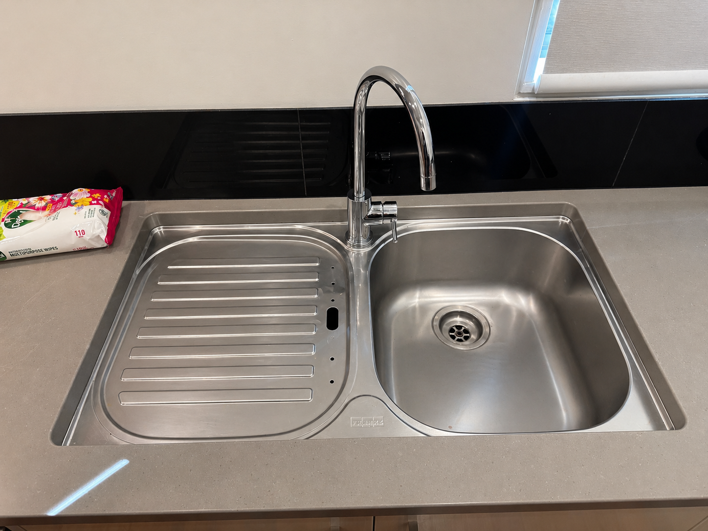 Clean kitchen sink and benchtop after detailed cleaning