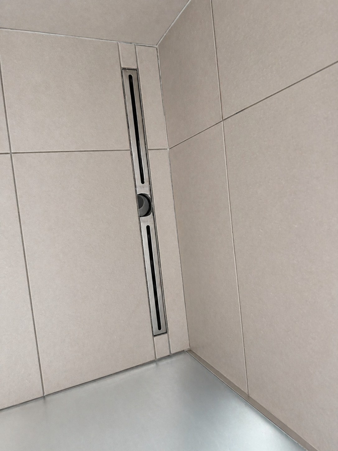 Clean shower tiles and drain after bathroom cleaning