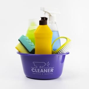 A purple bucket filled with various cleaning supplies including bottles and sponges.
